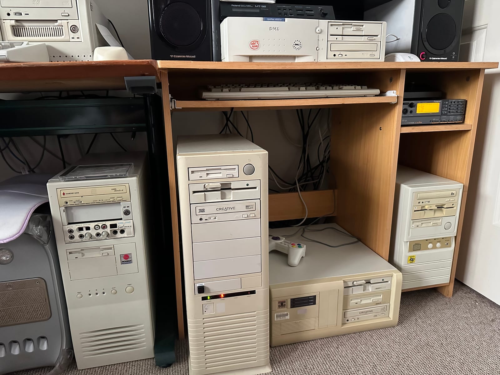 Shelves of vintage beige-box PCs and a retro setup from Ray's collection